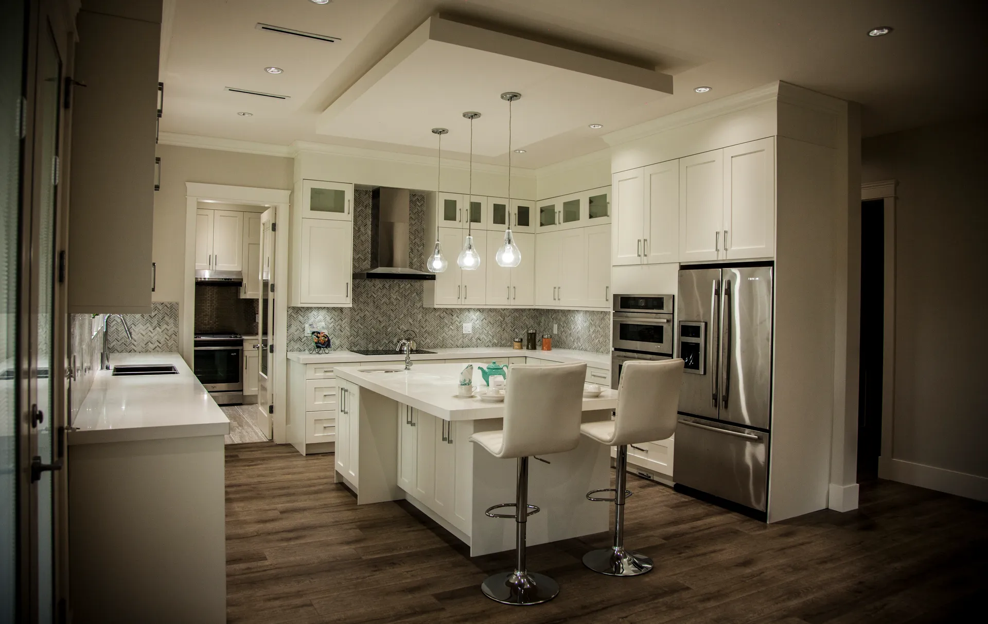Main kitchen with white island and stainless appliances