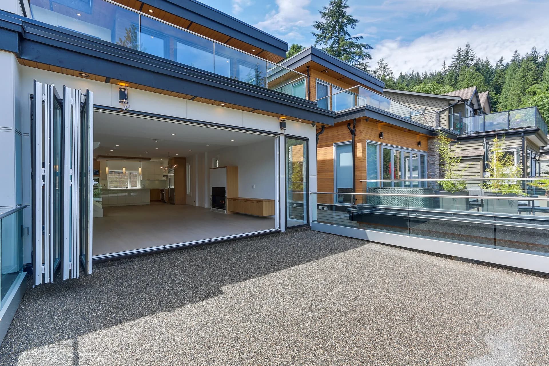 Aggregate roof deck with folding glass wall fully open to the living space