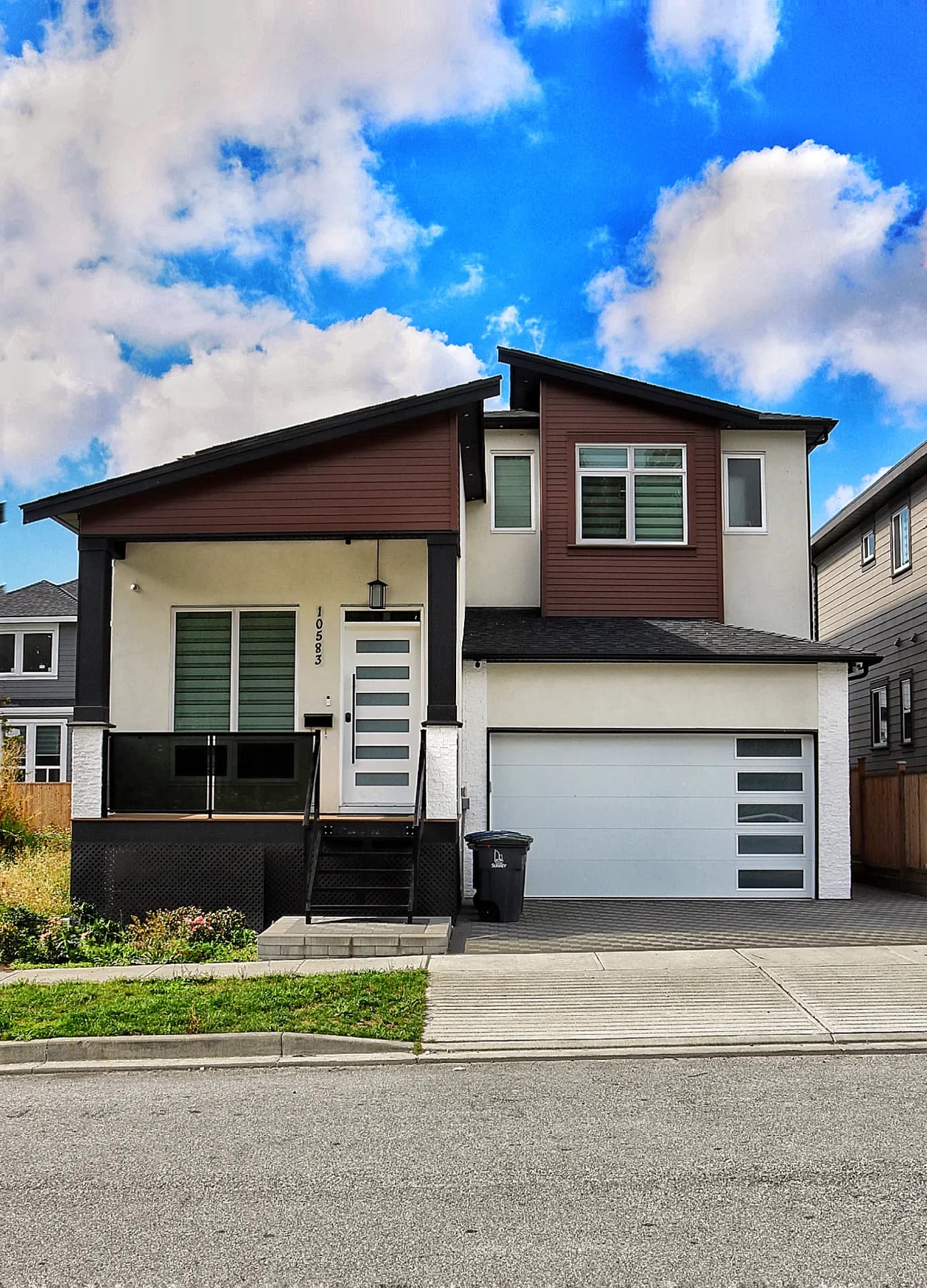 Surrey Modern, front exterior with white stucco, dark timber posts, and covered porch