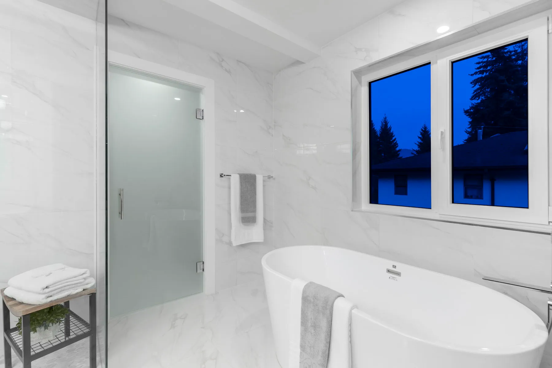 Marble clad ensuite with freestanding oval tub in the Lynn Valley Modern