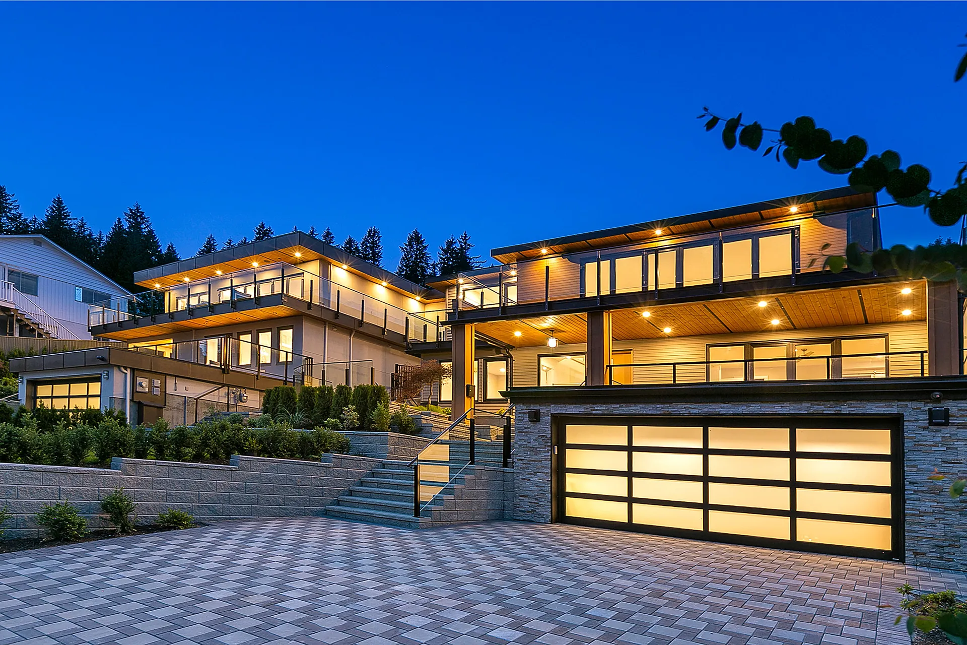 Lynn Valley three storey home at twilight on its hillside lot