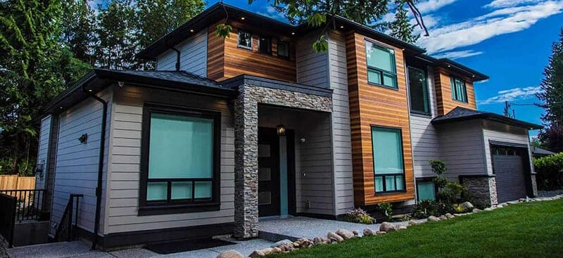 Modern custom home with stone and wood siding built by Major Homes