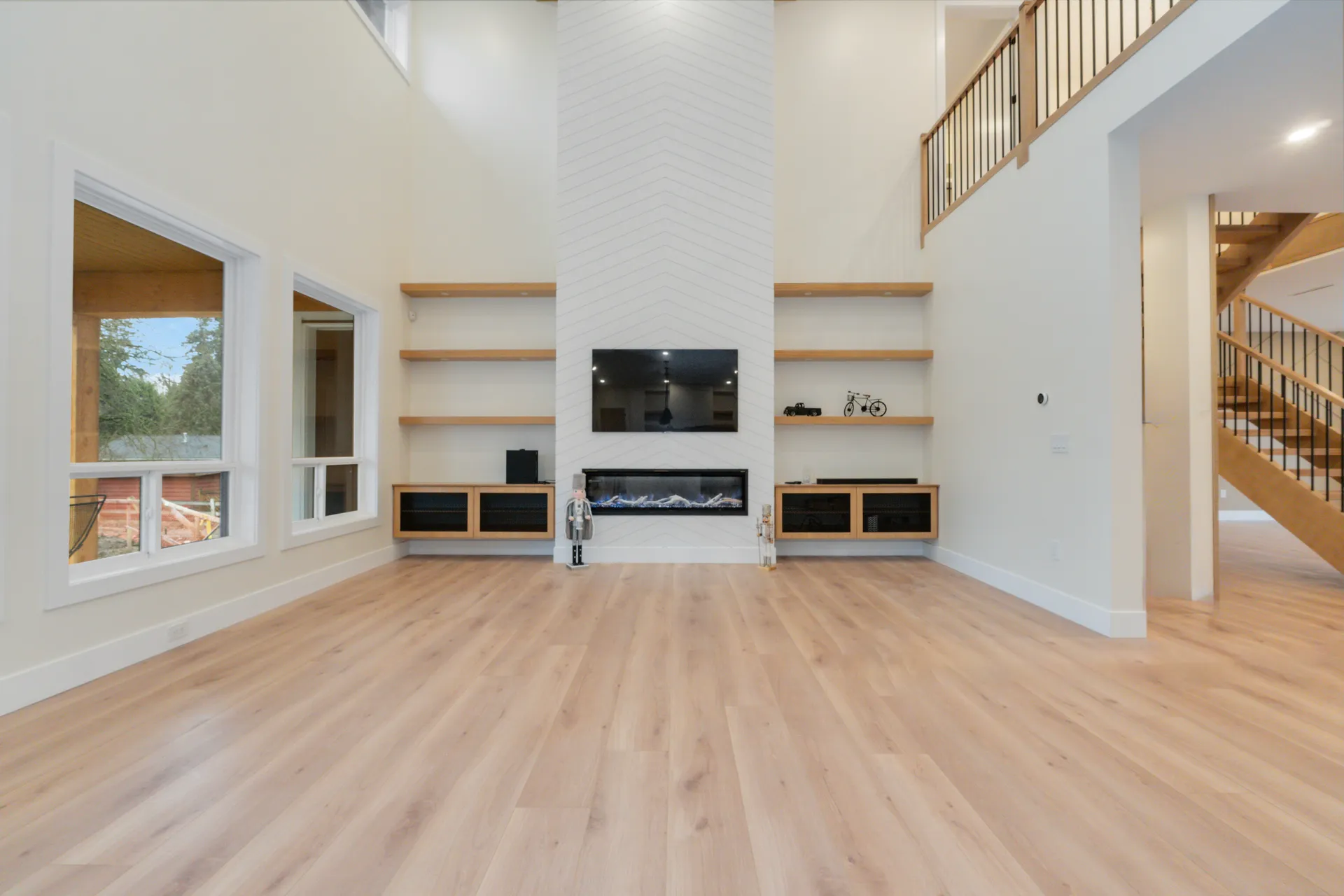 Finished double height great room with gallery railing in a Major Homes managed build