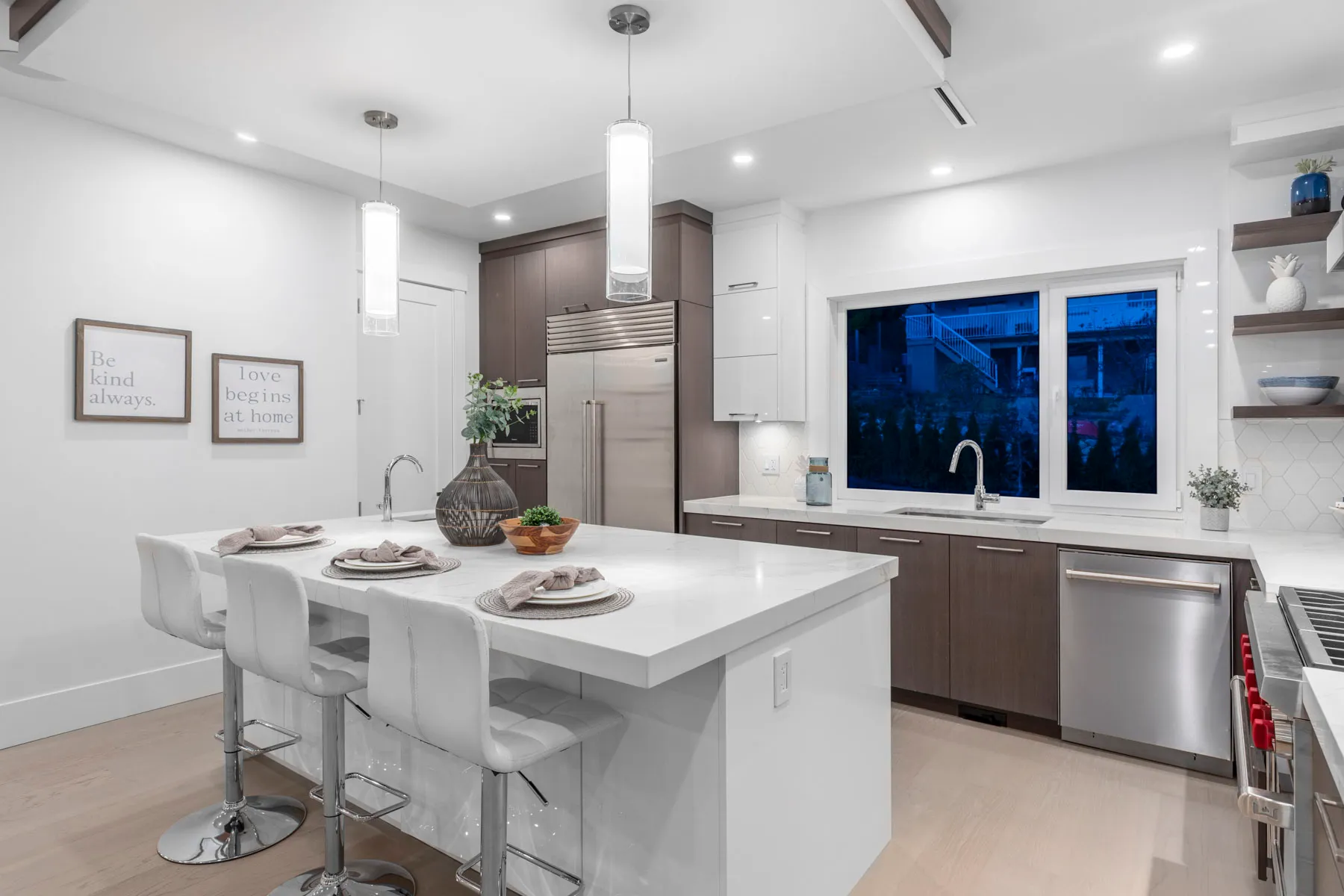 Custom kitchen with white quartz island and professional range in a Major Homes build
